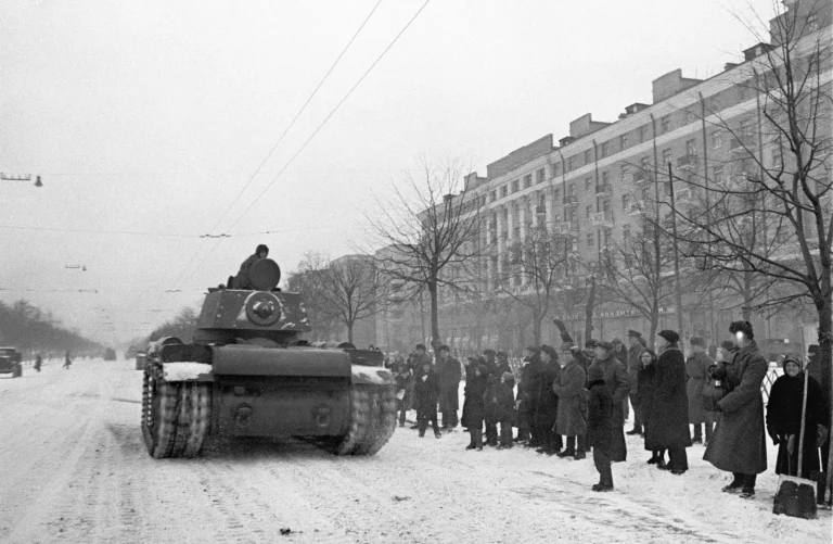 Парад 7 ноября 1941 года: танк КВ после парада идёт по улице Москвы к фронту, на тротуаре стоят москвичи